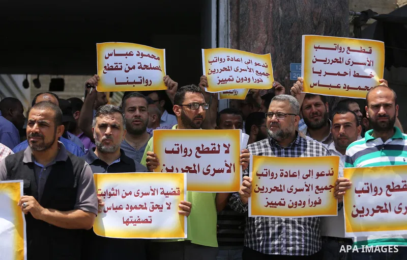 Palestinians take part in a protest demanding their salaries in Gaza city on July 6, 2017. Photo by Mohammed Asad