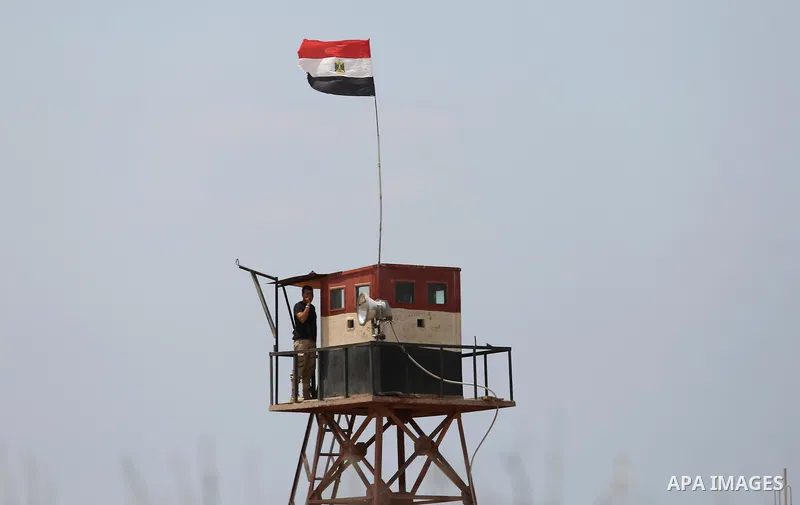 An Egyptian border stands guard on the border with Egypt, in the southern Gaza strip town of Rafah, on July 6, 2017. The buffer zone is expected to extend for a length of 12 kilometres and at a width of 100 metres along...