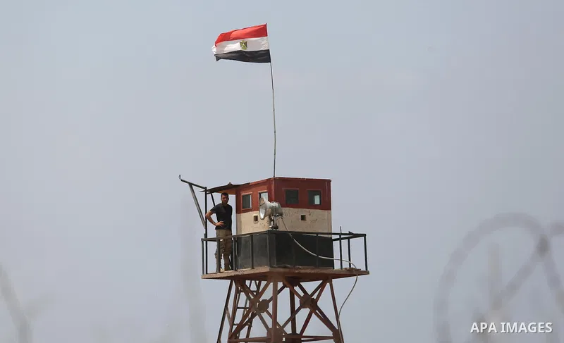 An Egyptian border stands guard on the border with Egypt, in the southern Gaza strip town of Rafah, on July 6, 2017. The buffer zone is expected to extend for a length of 12 kilometres and at a width of 100 metres along...