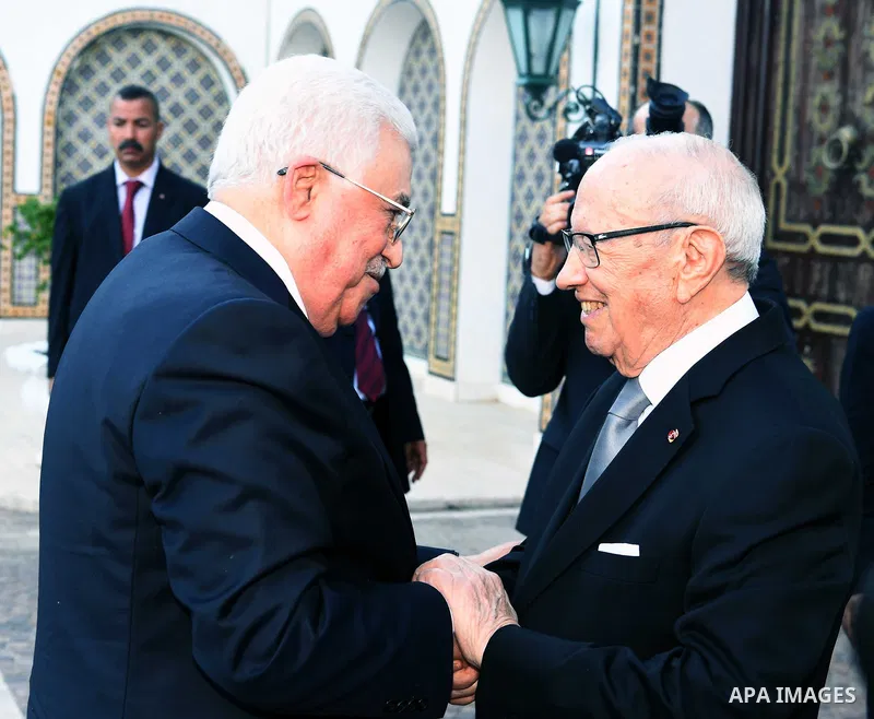 Tunisian President Beji Caid Essebsi shakes hands with Palestinian President Mahmoud Abbas during a welcome ceremony at Carthage Palace, near Tunis, on July 6, 2017. Abbas is on 2 day official visit to Tunisia. Photo by...