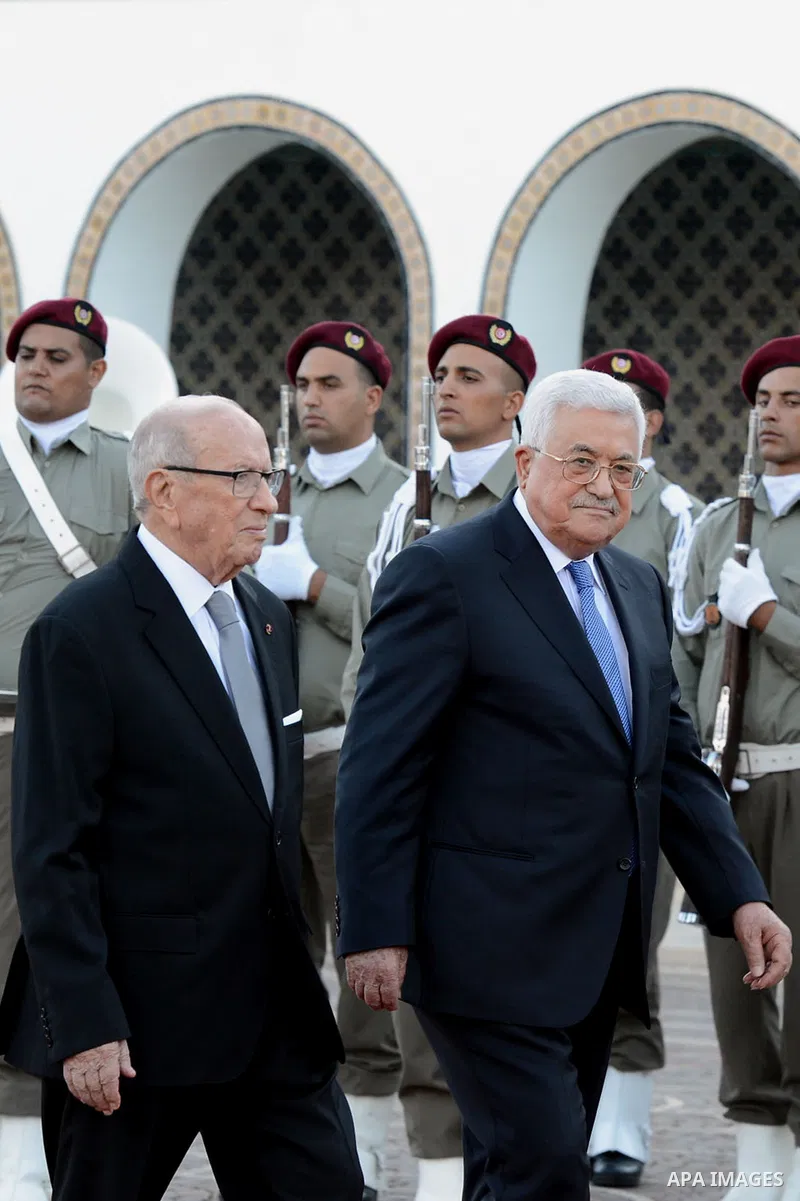 Tunisian President Beji Caid Essebsi reviews the honours guard with Palestinian President Mahmoud Abbas during a welcome ceremony at Carthage Palace, near Tunis, on July 6, 2017. Abbas is on 2 day official visit to Tunis...