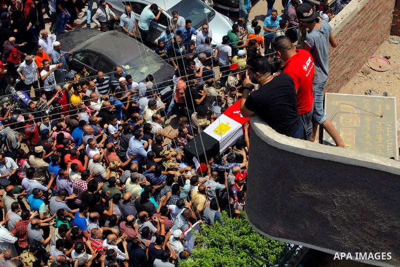 Egyptian relatives and friends carry the coffin of the officer Khaled al-Maghrabi, who was killed during a suicide bomb attack on an army checkpoint in Sinai, during his funeral in his hometown Toukh, Al Qalyubia Governo...