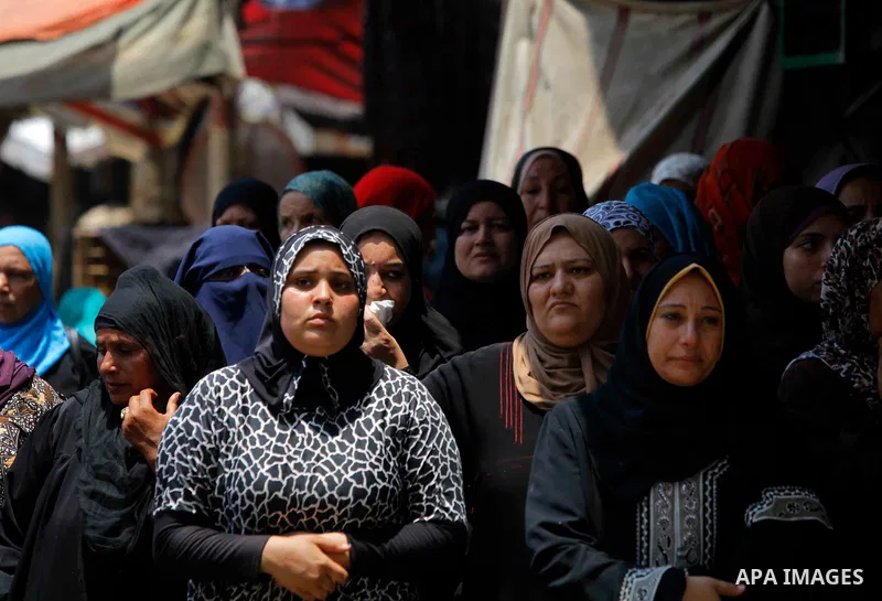 Egyptian relatives react during the funeral of officer Khaled al-Maghrabi, who was killed during a suicide bomb attack on an army checkpoint in Sinai, in his hometown Toukh, Al Qalyubia Governorate, north of Cairo, Egypt...