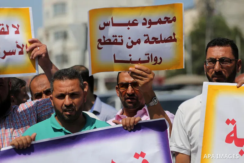 Palestinian released prisoners from Israeli jails hold placards during a protest demanding their salaries in Gaza city on July 9, 2017. Photo by Mohammed Asad