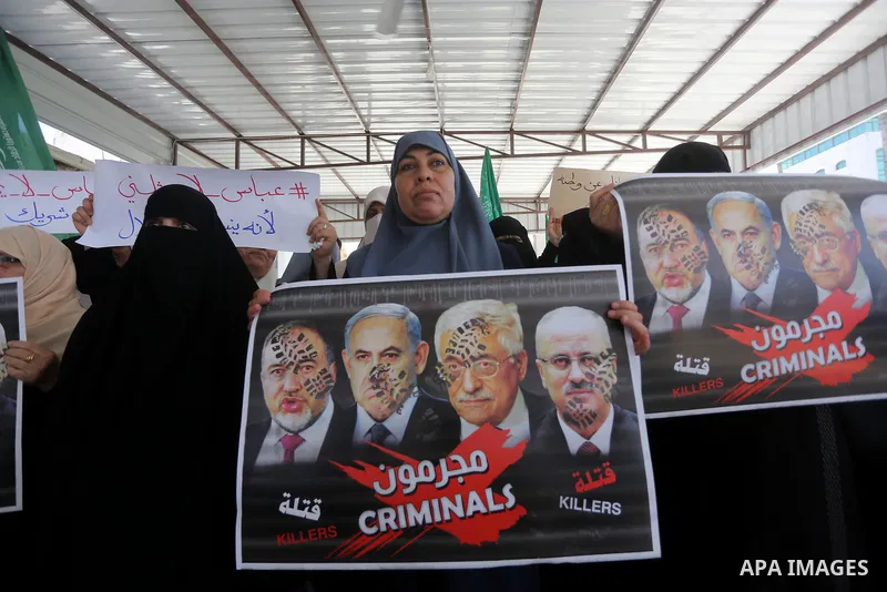 Palestinian women hold placards during a protest against Israeli blockade at Legislative council in Gaza city on July 9, 2017. Photo by Mohammed Asad