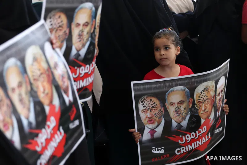 Palestinian women hold placards during a protest against Israeli blockade at Legislative council in Gaza city on July 9, 2017. Photo by Mohammed Asad