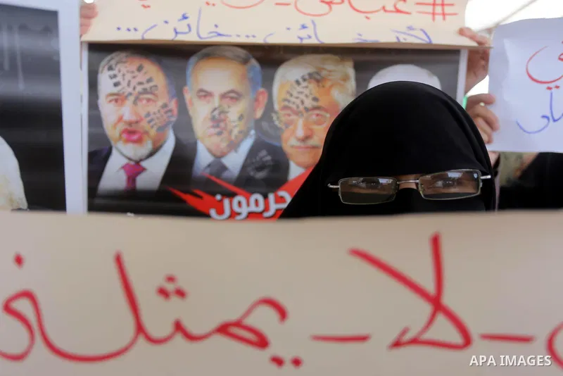 Palestinian women hold placards during a protest against Israeli blockade at Legislative council in Gaza city on July 9, 2017. Photo by Mohammed Asad