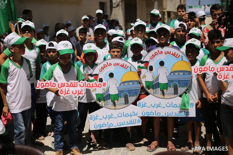 Palestinian children attend the start ceremony of summer camps organized by the Hamas movement in Gaza city on July 9, 2017. Photo by Ashraf Amra