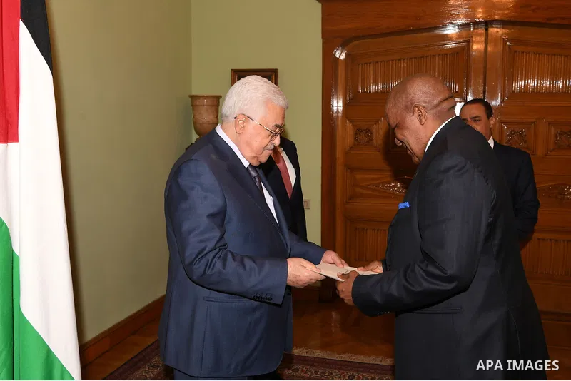 Palestinian President Mahmoud Abbas accepts the papers of the Ambassador of the Republic of Napia to the State of Palestine in Cairo, Egypt, on July 8, 2017. Photo by Thaer Ganaim