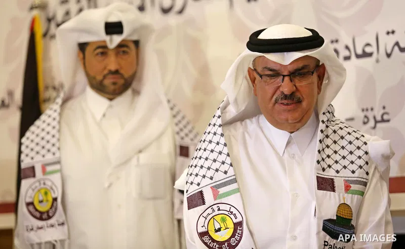 Qatar's Ambassador to the Palestinian Authority, Mohammed Al Emadi, delivers financial payments to the project to repair the homes of poor families, in Gaza city on July 10, 2017. Photo by Ashraf Amra