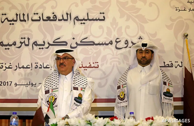Qatar's Ambassador to the Palestinian Authority, Mohammed Al Emadi, delivers financial payments to the project to repair the homes of poor families, in Gaza city on July 10, 2017. Photo by Ashraf Amra