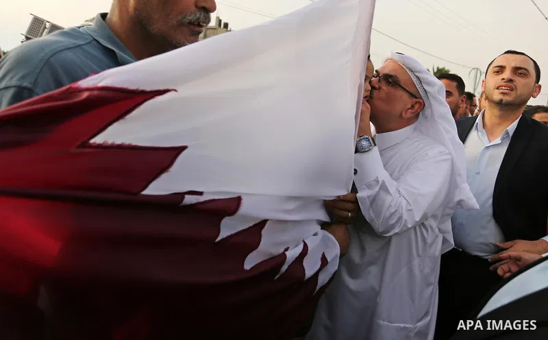 Qatar's Ambassador to the Palestinian Authority, Mohammed Al Emadi kisses a Palestinian girl during the opening ceremony of rebuild Salah Al-Deen street project -Phase IV- funded by Qatar in al-Nusairat in the center of...