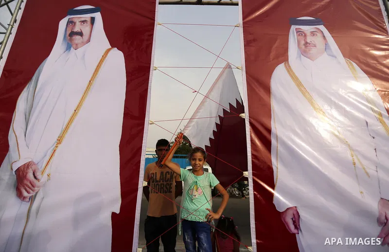 Palestinians wave the Qatar flag during the opening ceremony of rebuild Salah Al-Deen street project -Phase IV- funded by Qatar in al-Nusairat in the center of Gaza strip, on July 11, 2017. Photo by Ashraf Amra