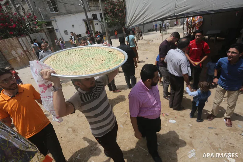 Relatives of a Palestinian high school student, Loa'y Qnoua 99.7, celebrate after heard the results of his final exams known as ''Tawjihi'', in Gaza city on July 12, 2017. Photo by Mohammed Asad