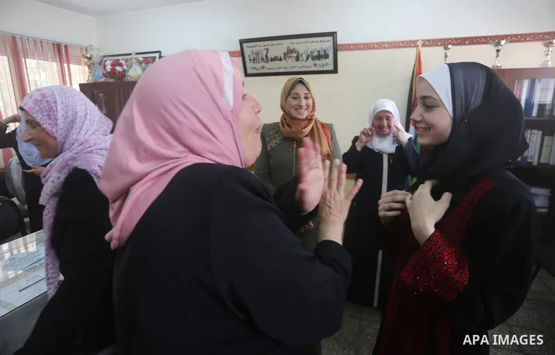 Palestinian high school female students celebrate after heard their results of final exams known as "Tawjihi" in Gaza city on July 12, 2017. Photo by Mohammed Asad