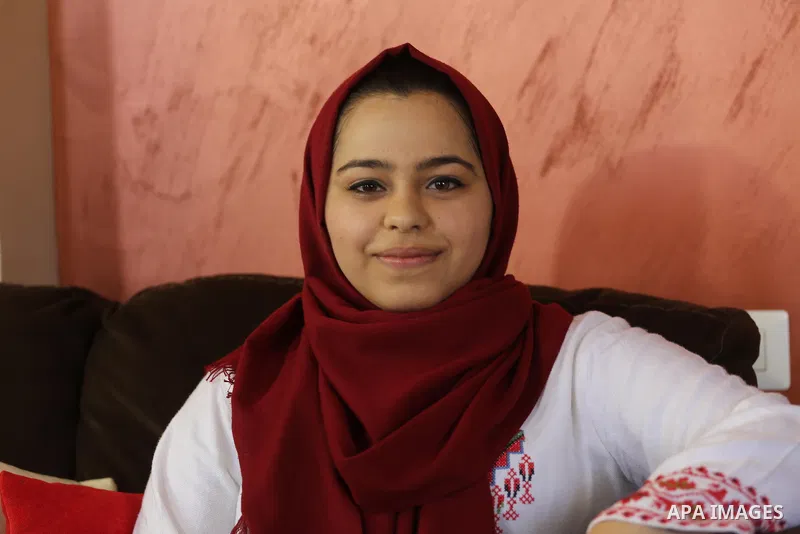 A Palestinian high school student, Malak Matar 99.3, poses for a photo after heard the results of her final exams known as ''Tawjihi'', in Gaza city on July 12, 2017. Photo by Mohammed Asad