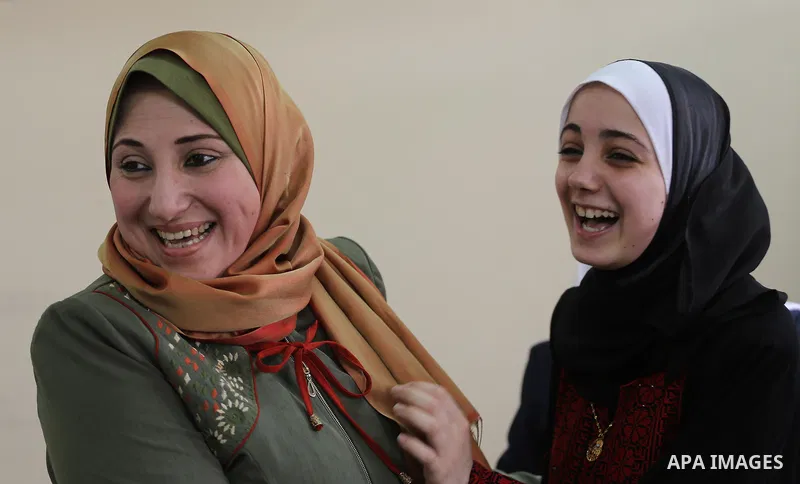 Palestinian high school female students celebrate after heard their results of final exams known as "Tawjihi" in Gaza city on July 12, 2017. Photo by Mohammed Asad