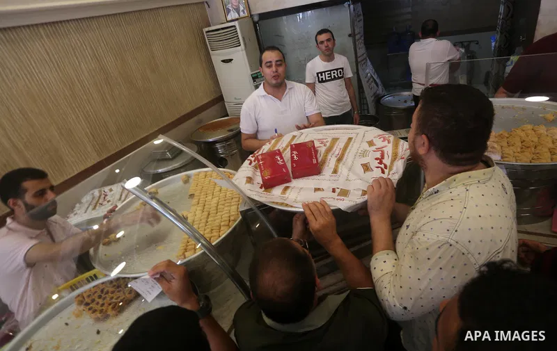 Palestinian vendors sell sweets after the results of high school exams, known as ''Tawjihi'', in Gaza city on July 12, 2017. Photo by Mohammed Asad