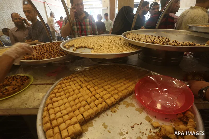 Palestinian vendors sell sweets after the results of high school exams, known as ''Tawjihi'', in Gaza city on July 12, 2017. Photo by Mohammed Asad