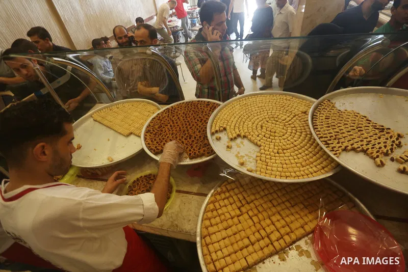 Palestinian vendors sell sweets after the results of high school exams, known as ''Tawjihi'', in Gaza city on July 12, 2017. Photo by Mohammed Asad