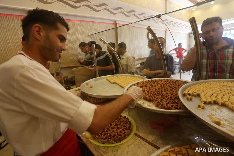 Palestinian vendors sell sweets after the results of high school exams, known as ''Tawjihi'', in Gaza city on July 12, 2017. Photo by Mohammed Asad