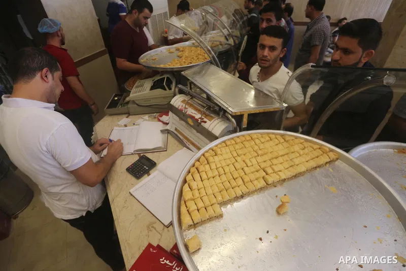 Palestinian vendors sell sweets after the results of high school exams, known as ''Tawjihi'', in Gaza city on July 12, 2017. Photo by Mohammed Asad