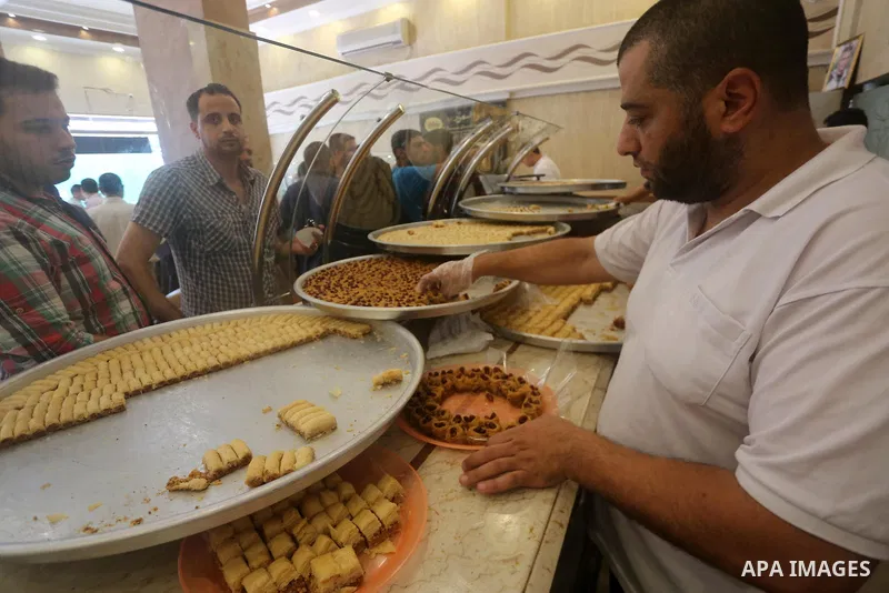 Palestinian vendors sell sweets after the results of high school exams, known as ''Tawjihi'', in Gaza city on July 12, 2017. Photo by Mohammed Asad
