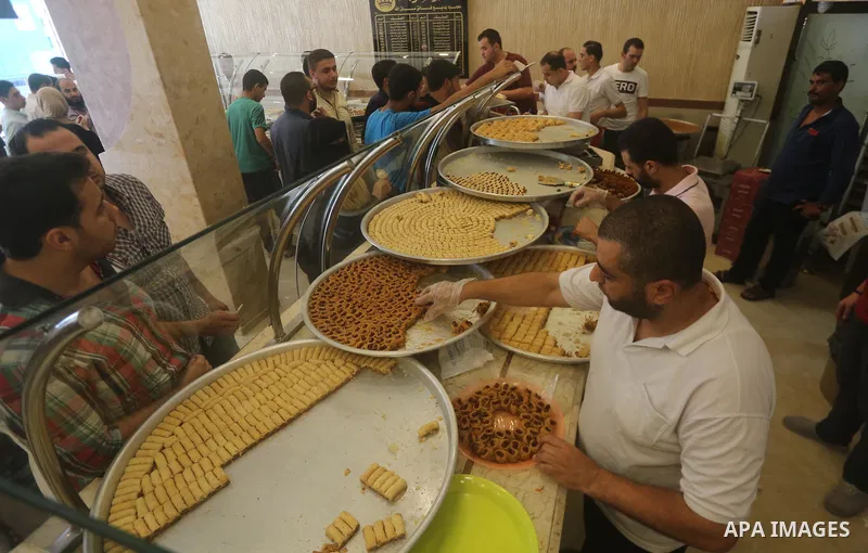Palestinian vendors sell sweets after the results of high school exams, known as ''Tawjihi'', in Gaza city on July 12, 2017. Photo by Mohammed Asad