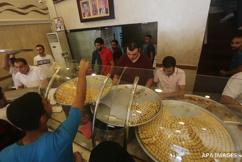 Palestinian vendors sell sweets after the results of high school exams, known as ''Tawjihi'', in Gaza city on July 12, 2017. Photo by Mohammed Asad