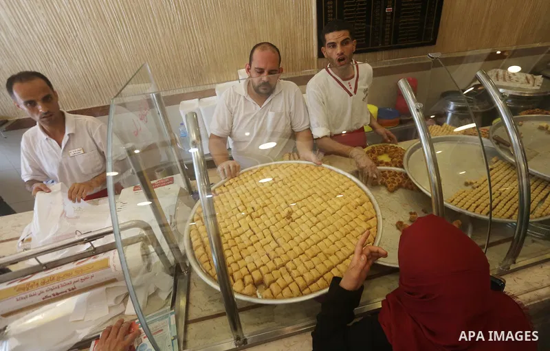 Palestinian vendors sell sweets after the results of high school exams, known as ''Tawjihi'', in Gaza city on July 12, 2017. Photo by Mohammed Asad