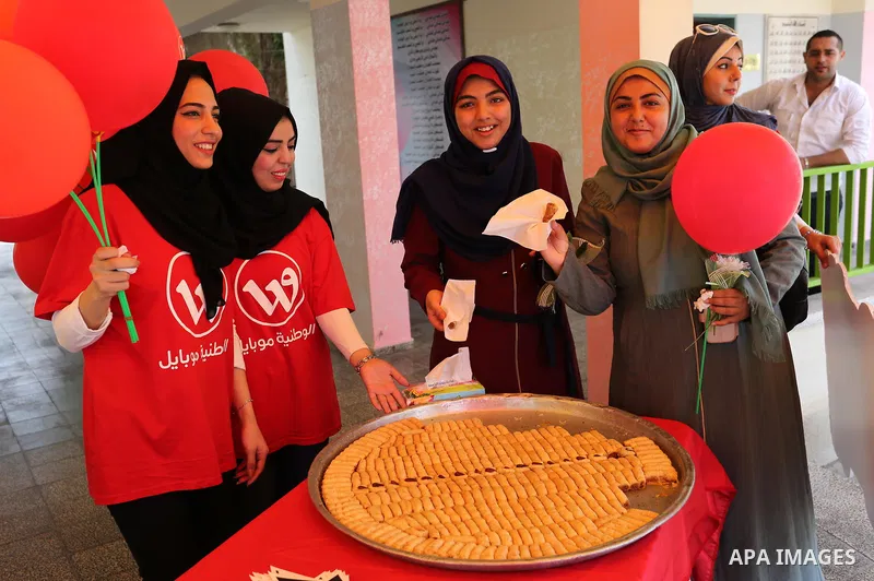 Palestinian high school female students celebrate after heard their results of final exams known as "Tawjihi", in Gaza city on July 12, 2017. Photo by Ashraf Amra