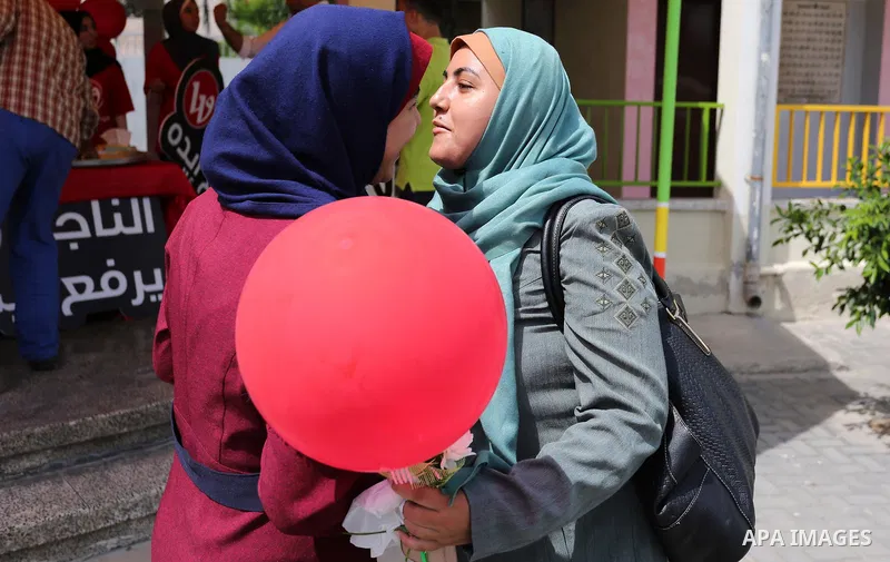 Palestinian high school female students celebrate after heard their results of final exams known as "Tawjihi", in Gaza city on July 12, 2017. Photo by Ashraf Amra