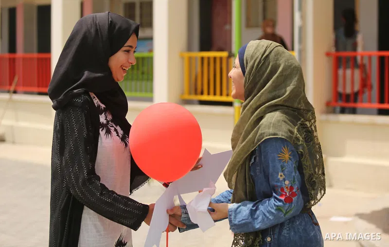 Palestinian high school female students celebrate after heard their results of final exams known as "Tawjihi", in Gaza city on July 12, 2017. Photo by Ashraf Amra