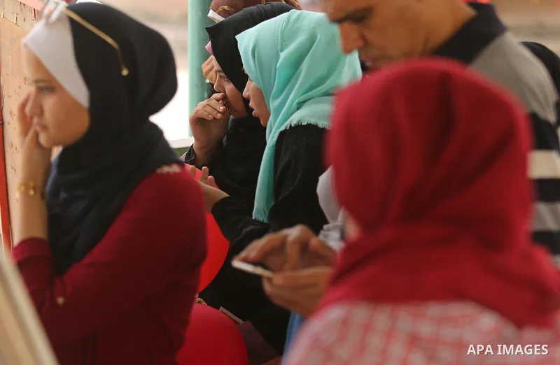 Palestinian high school students look for their results of final high school exams, known as "Tawjihi", in Gaza city on July 12, 2017. Photo by Ashraf Amra