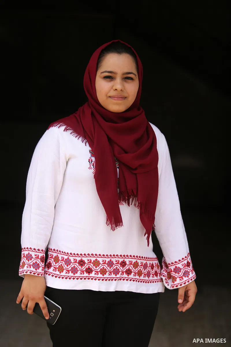 A Palestinian high school student, Malak Matar 99.3, poses for a photo after heard the results of her final exams known as ''Tawjihi'', in Gaza city on July 12, 2017. Photo by Ashraf Amra