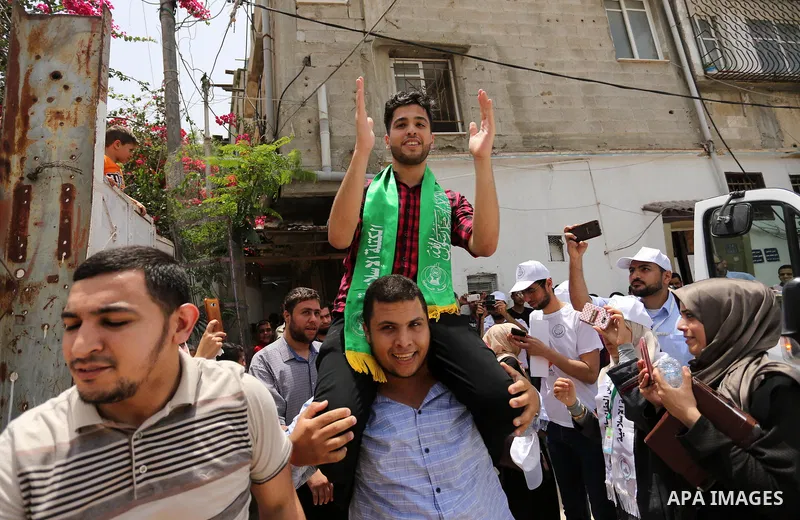 A Palestinian high school student, Loa'y Qnoua 99.7, celebrates with his family after heard the results of his final exams known as ''Tawjihi'', in Gaza city on July 12, 2017. Photo by Ashraf Amra