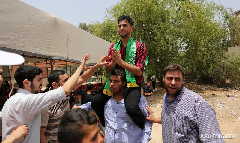A Palestinian high school student, Loa'y Qnoua 99.7, celebrates with his family after heard the results of his final exams known as ''Tawjihi'', in Gaza city on July 12, 2017. Photo by Ashraf Amra