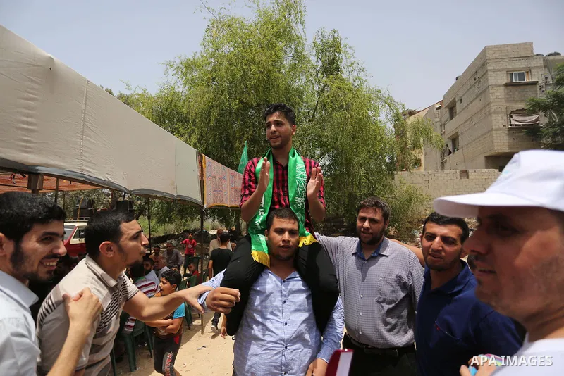 A Palestinian high school student, Loa'y Qnoua 99.7, celebrates with his family after heard the results of his final exams known as ''Tawjihi'', in Gaza city on July 12, 2017. Photo by Ashraf Amra