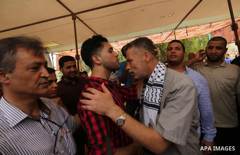 A Palestinian high school student, Loa'y Qnoua 99.7, celebrates with his family after heard the results of his final exams known as ''Tawjihi'', in Gaza city on July 12, 2017. Photo by Ashraf Amra