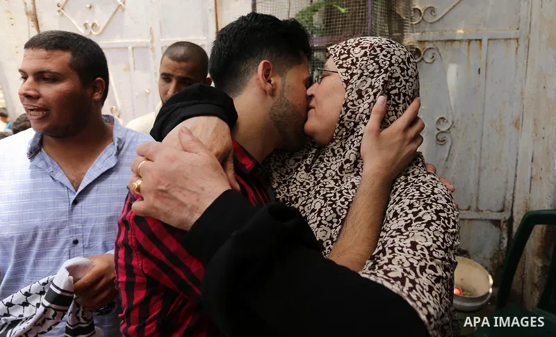 A Palestinian high school student, Loa'y Qnoua 99.7, celebrates with his family after heard the results of his final exams known as ''Tawjihi'', in Gaza city on July 12, 2017. Photo by Ashraf Amra