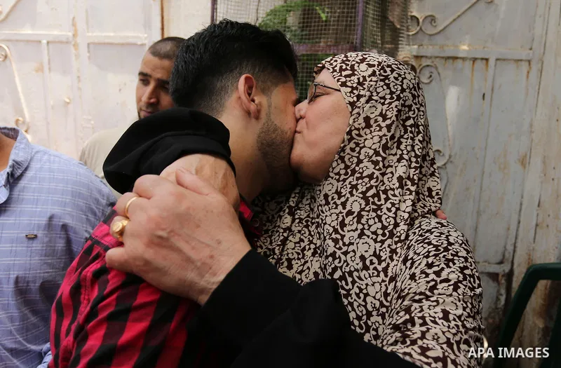 A Palestinian high school student, Loa'y Qnoua 99.7, celebrates with his family after heard the results of his final exams known as ''Tawjihi'', in Gaza city on July 12, 2017. Photo by Ashraf Amra