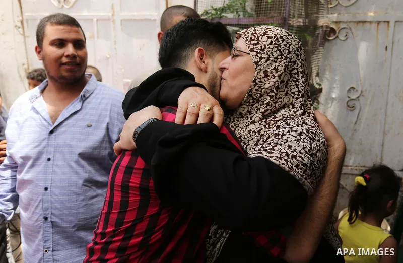A Palestinian high school student, Loa'y Qnoua 99.7, celebrates with his family after heard the results of his final exams known as ''Tawjihi'', in Gaza city on July 12, 2017. Photo by Ashraf Amra