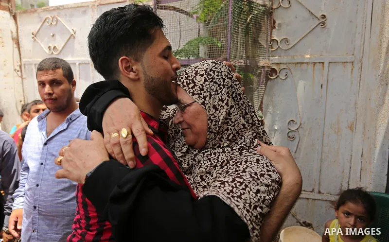 A Palestinian high school student, Loa'y Qnoua 99.7, celebrates with his family after heard the results of his final exams known as ''Tawjihi'', in Gaza city on July 12, 2017. Photo by Ashraf Amra