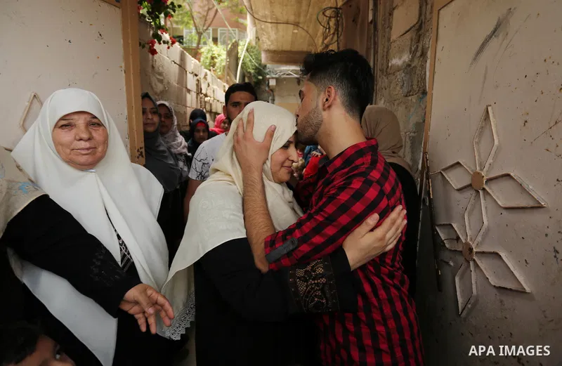 A Palestinian high school student, Loa'y Qnoua 99.7, celebrates with his family after heard the results of his final exams known as ''Tawjihi'', in Gaza city on July 12, 2017. Photo by Ashraf Amra