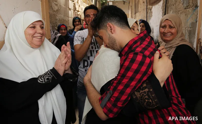 A Palestinian high school student, Loa'y Qnoua 99.7, celebrates with his family after heard the results of his final exams known as ''Tawjihi'', in Gaza city on July 12, 2017. Photo by Ashraf Amra