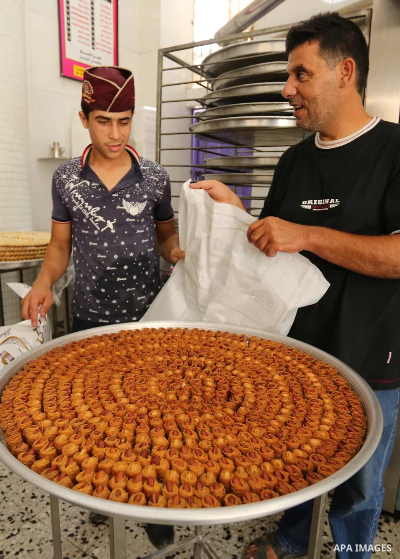 Palestinian vendors sell sweets after the results of high school exams, known as ''Tawjihi'', in Gaza city on July 12, 2017. Photo by Ashraf Amra