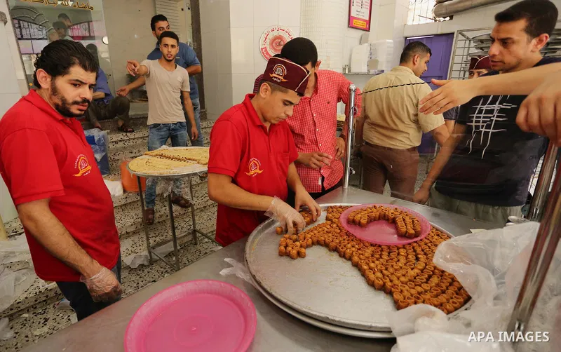 Palestinian vendors sell sweets after the results of high school exams, known as ''Tawjihi'', in Gaza city on July 12, 2017. Photo by Ashraf Amra