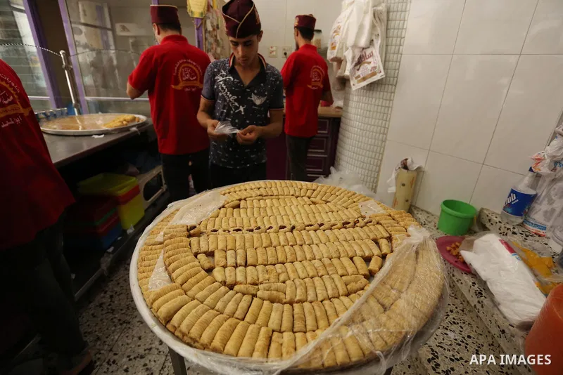 Palestinian vendors sell sweets after the results of high school exams, known as ''Tawjihi'', in Gaza city on July 12, 2017. Photo by Ashraf Amra
