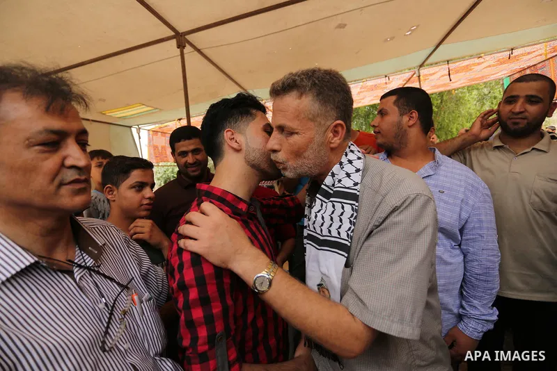 A Palestinian high school student, Loa'y Qnoua 99.7, celebrates with his family after heard the results of his final exams known as ''Tawjihi'', in Gaza city on July 12, 2017. Photo by Ashraf Amra