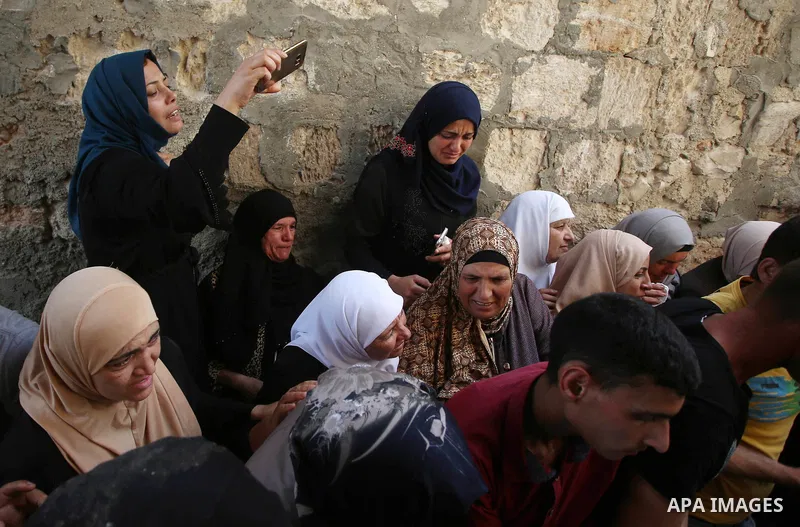 Relatives of 21-year-old Saad Salah mourn during the funeral of Saad and 17-year-old Aws Salame, who were shot dead during clashes with the Israeli security forces in the West Bank city of Jenin, on July 12, 2017. Photo...